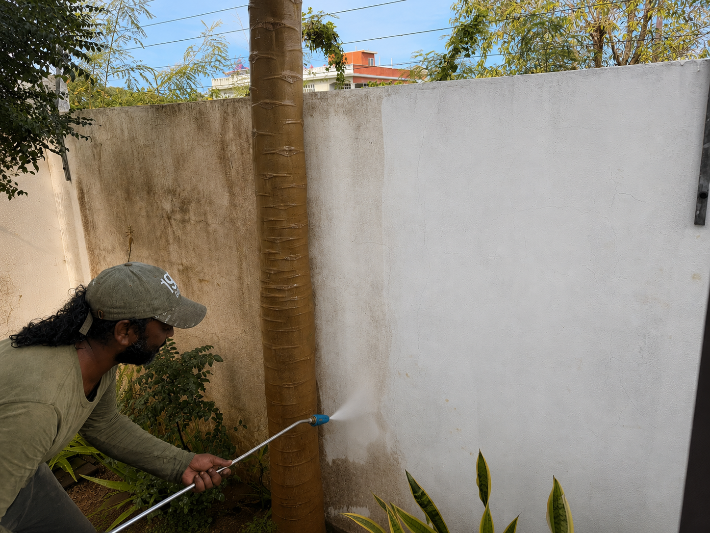 Smartstay team member cleaning an immediate exterior wall surface